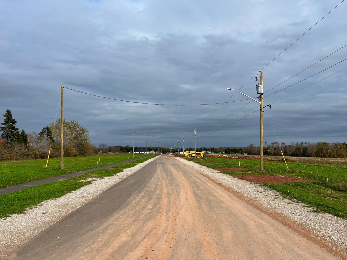 New neighbourhood paved road that is straight.