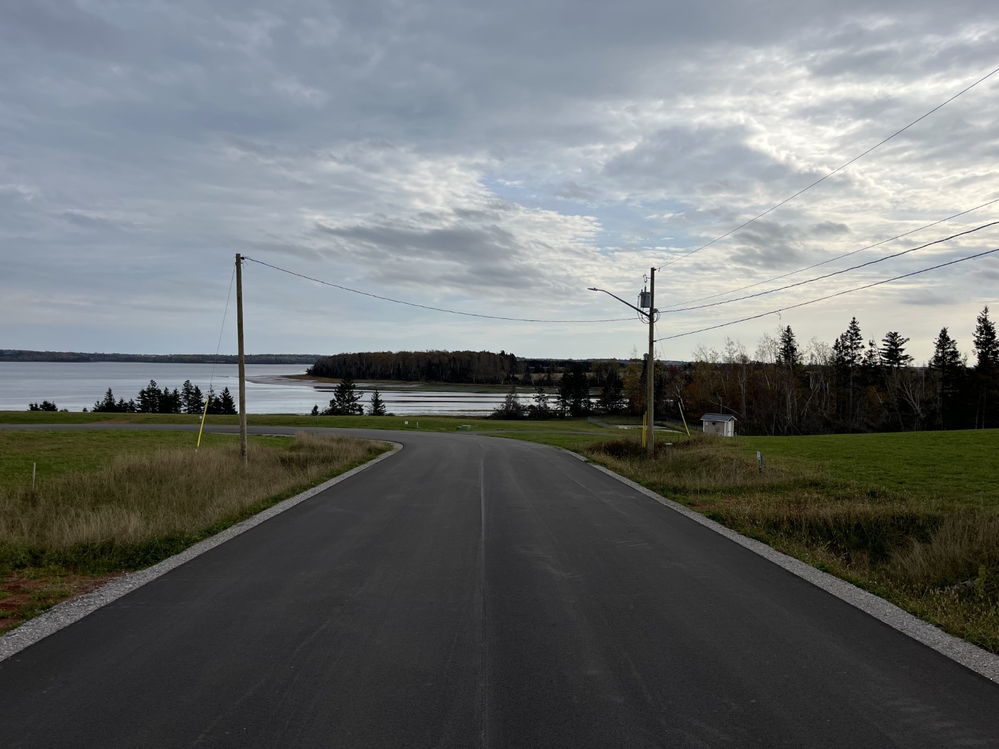 Paved service road that has a corner.