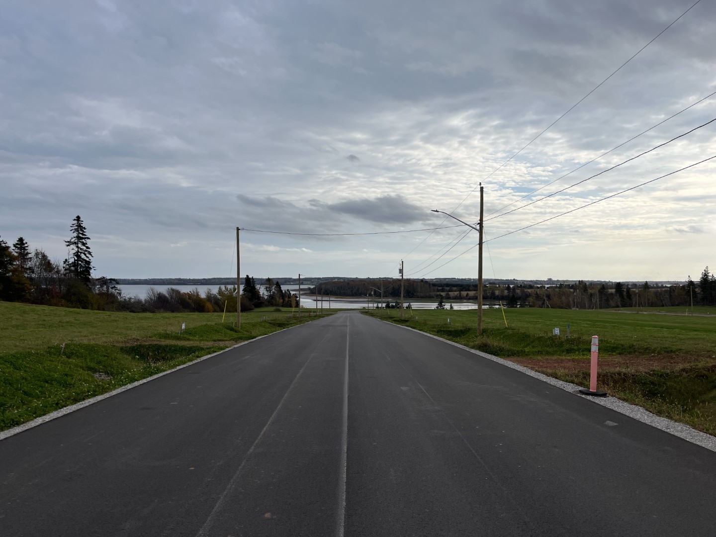 Paved service road, on a cloudy day.