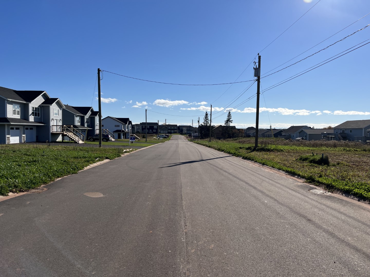 Windsor Park paved road with new homes on the left and ready to build lots on the right.
