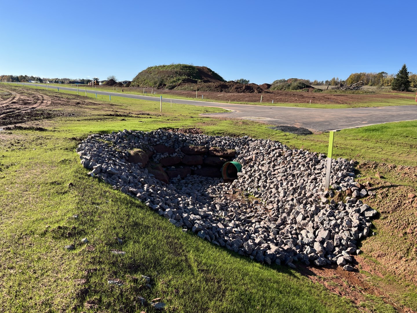 looking into Woodland Creek drainage ditch with large rock and culvert.